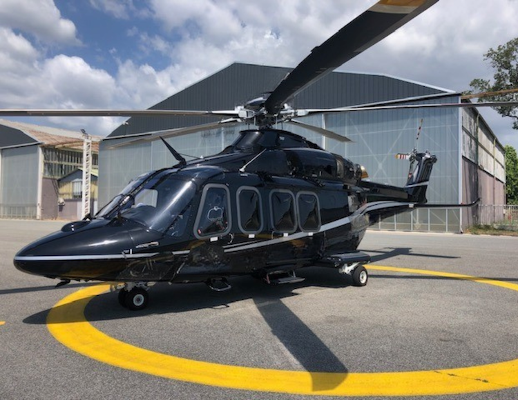 Black Leonardo AW139 VIP helicopter on a helipad