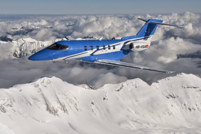 Pilatus PC-24 business jet flying above the Alps